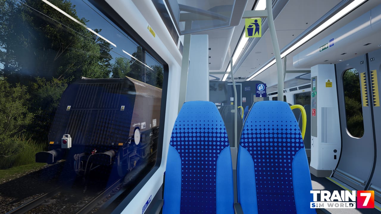 Passenger saloon of a Northern unit as a hopper wagon passes the window in Train Sim World 7